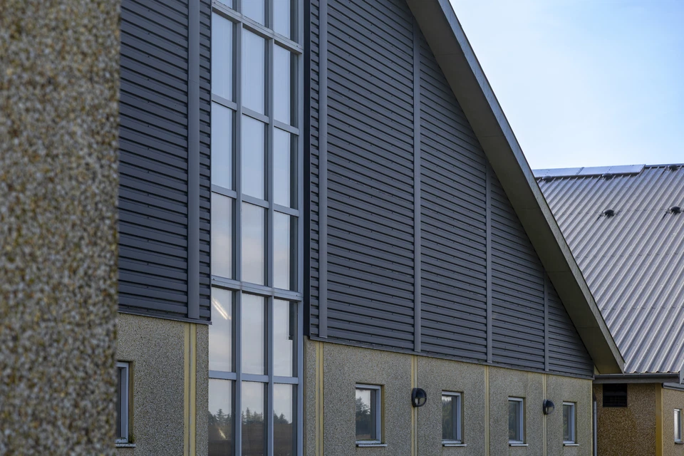 Man standing infront of the ocean with his arms spread out
