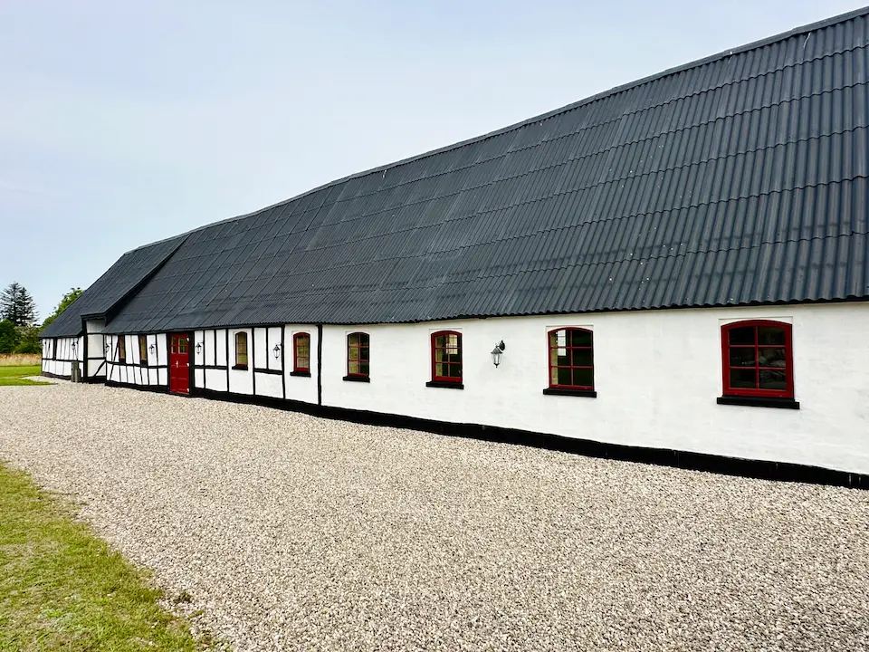 Man standing infront of the ocean with his arms spread out