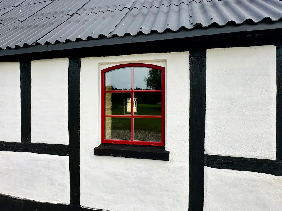 Man standing infront of the ocean with his arms spread out